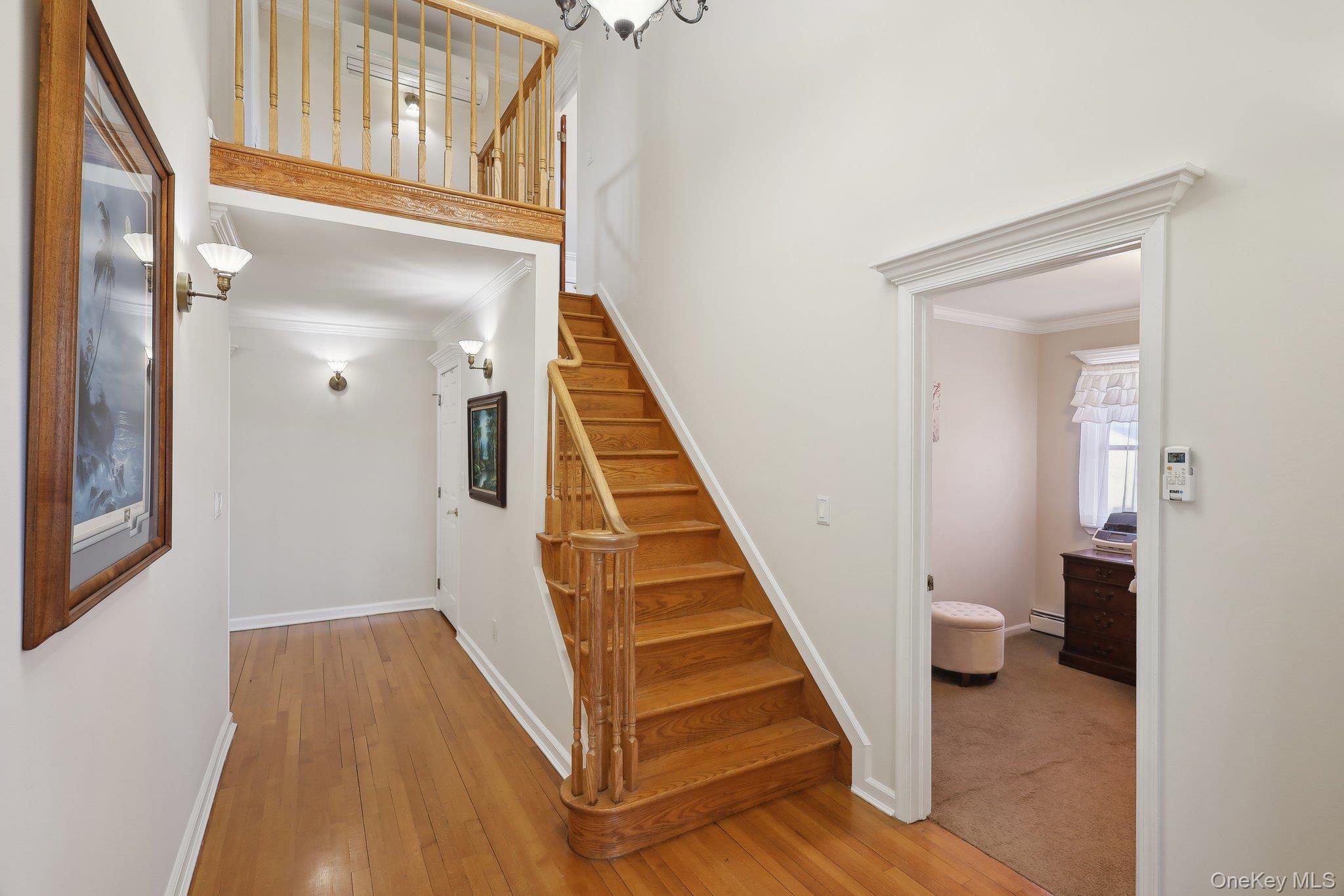 230 West Islip Road West Islip, NY 11795 - Photo 37 of 50 Staircase with wood-type flooring, baseboard heating, baseboards, and ornamental molding