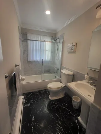 a bathroom with a toilet a sink and bathtub