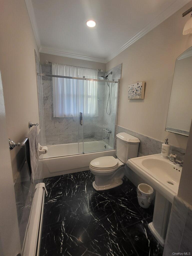 230 West Islip Road West Islip, NY 11795 - Photo 39 of 50 Bathroom with toilet, marble finish flooring, shower / bath combination with glass door, crown molding, and recessed lighting