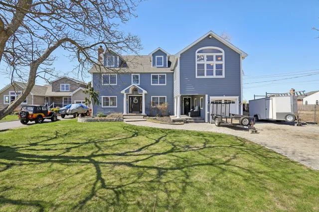 a front view of a building with a garden