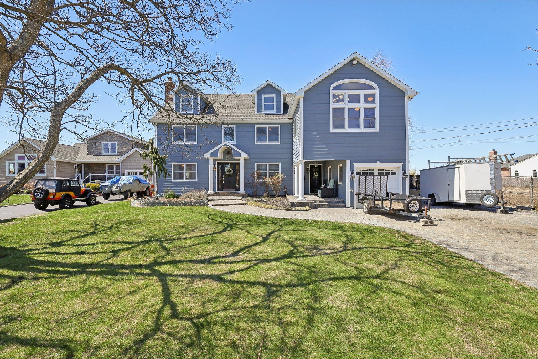 230 West Islip Road West Islip, NY 11795 - Photo 4 of 49 a front view of a building with a garden