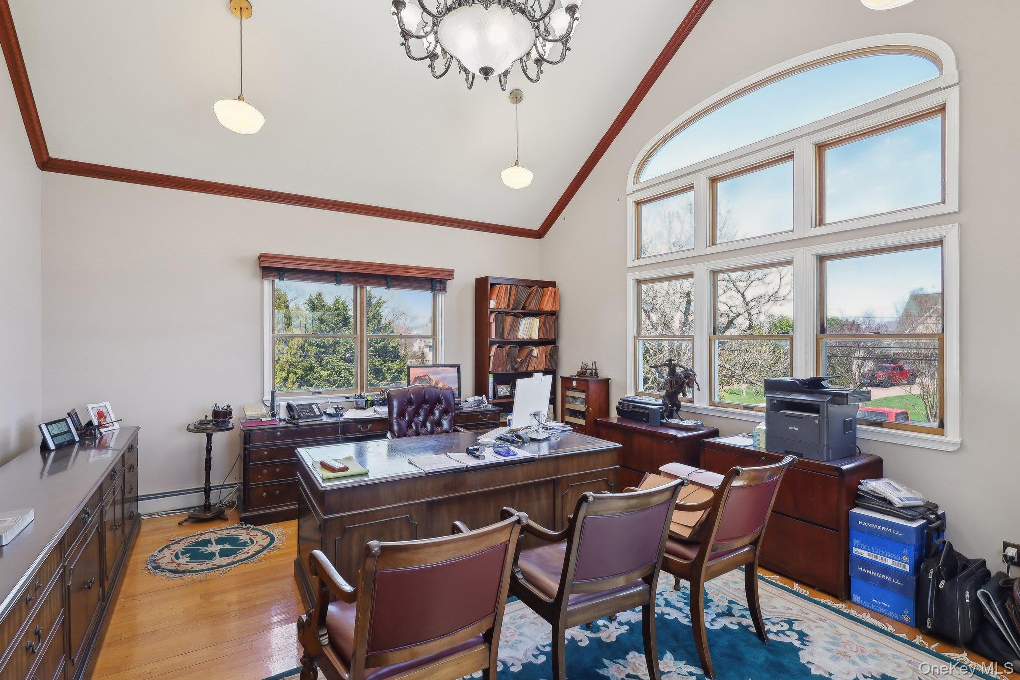 230 West Islip Road West Islip, NY 11795 - Photo 41 of 50 Home office with baseboard heating, crown molding, high vaulted ceiling, and light wood finished floors