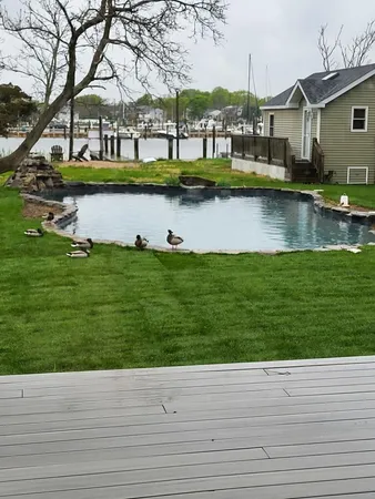 a view of house with yard tennis court