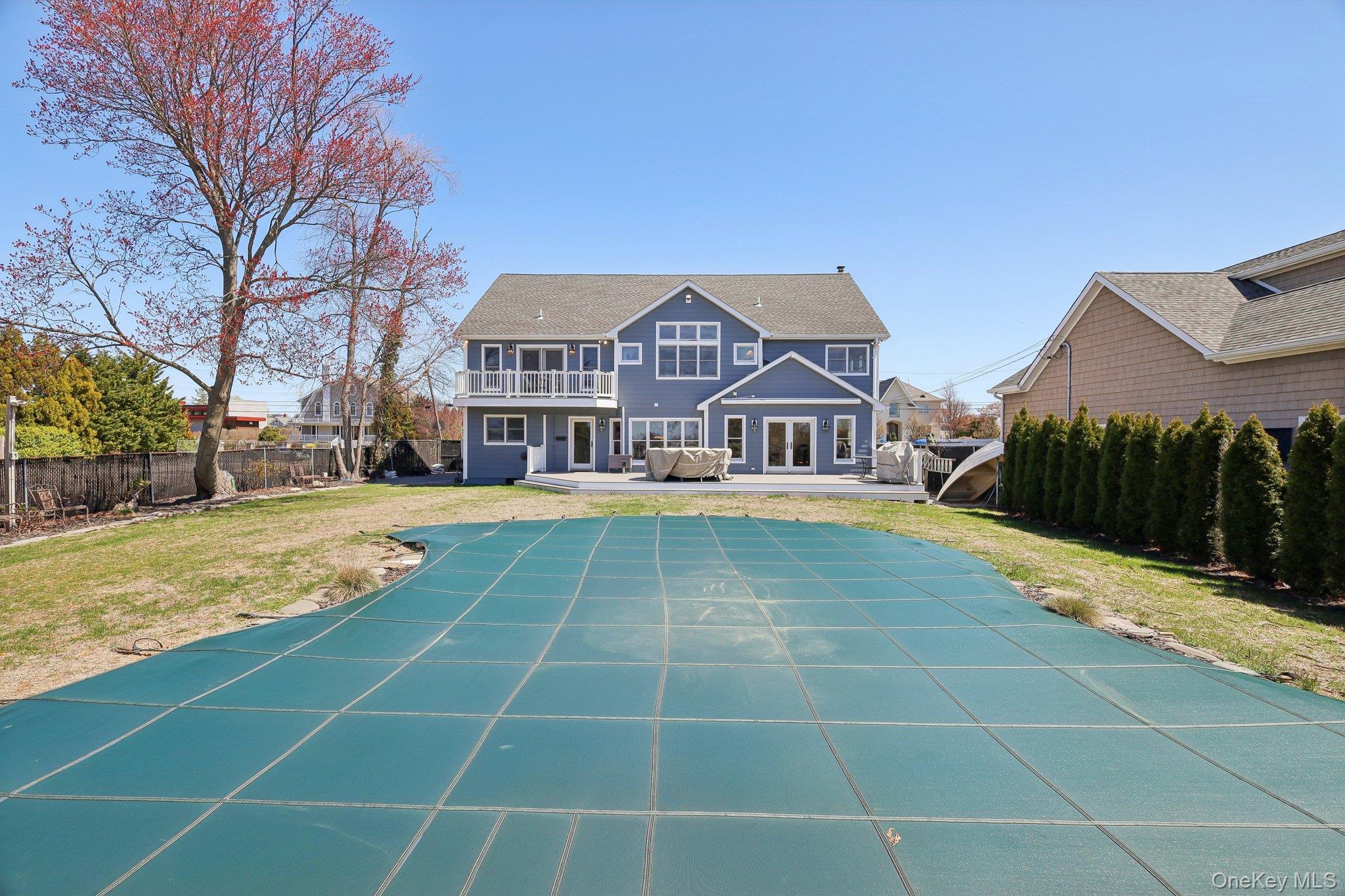 230 West Islip Road West Islip, NY 11795 - Photo 46 of 50 Rear view of house featuring a patio area, a balcony, a fenced backyard, and a lawn
