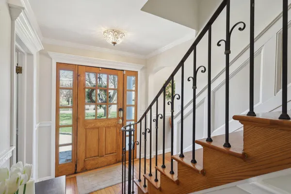 a view of an entryway with wooden floor and door