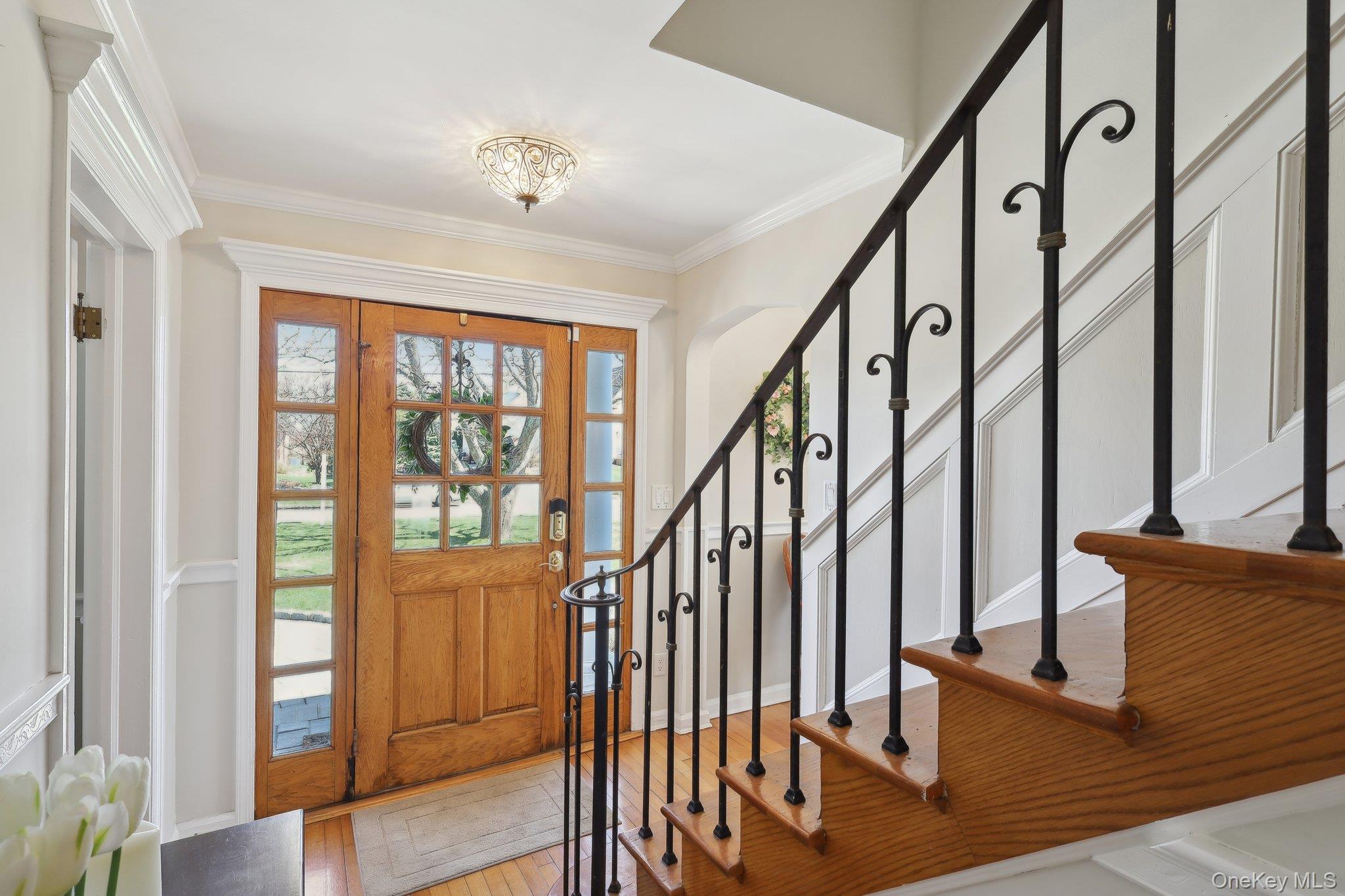 230 West Islip Road West Islip, NY 11795 - Photo 8 of 50 Entryway with crown molding, light wood finished floors, and stairs