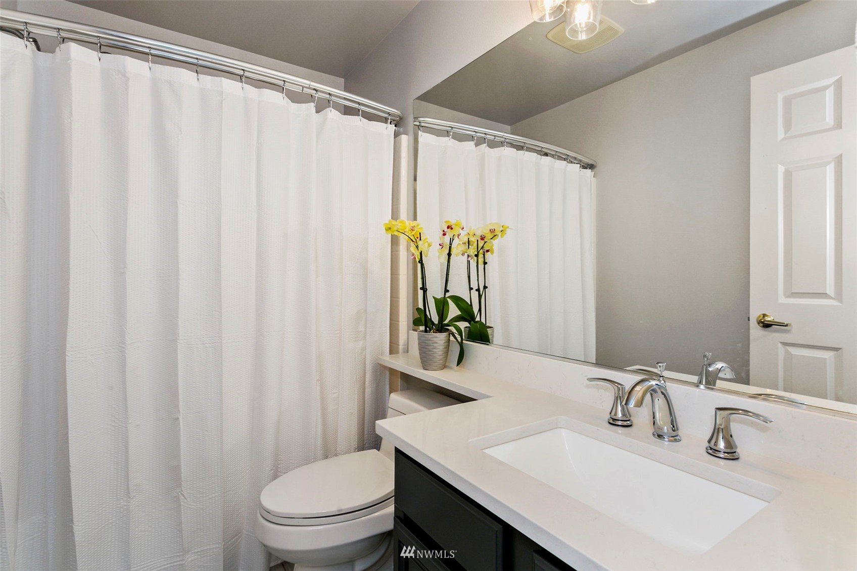 18487 Rainier View Road Southeast Monroe, WA 98272 - Photo 12 of 19 a bathroom with a sink a toilet and a mirror