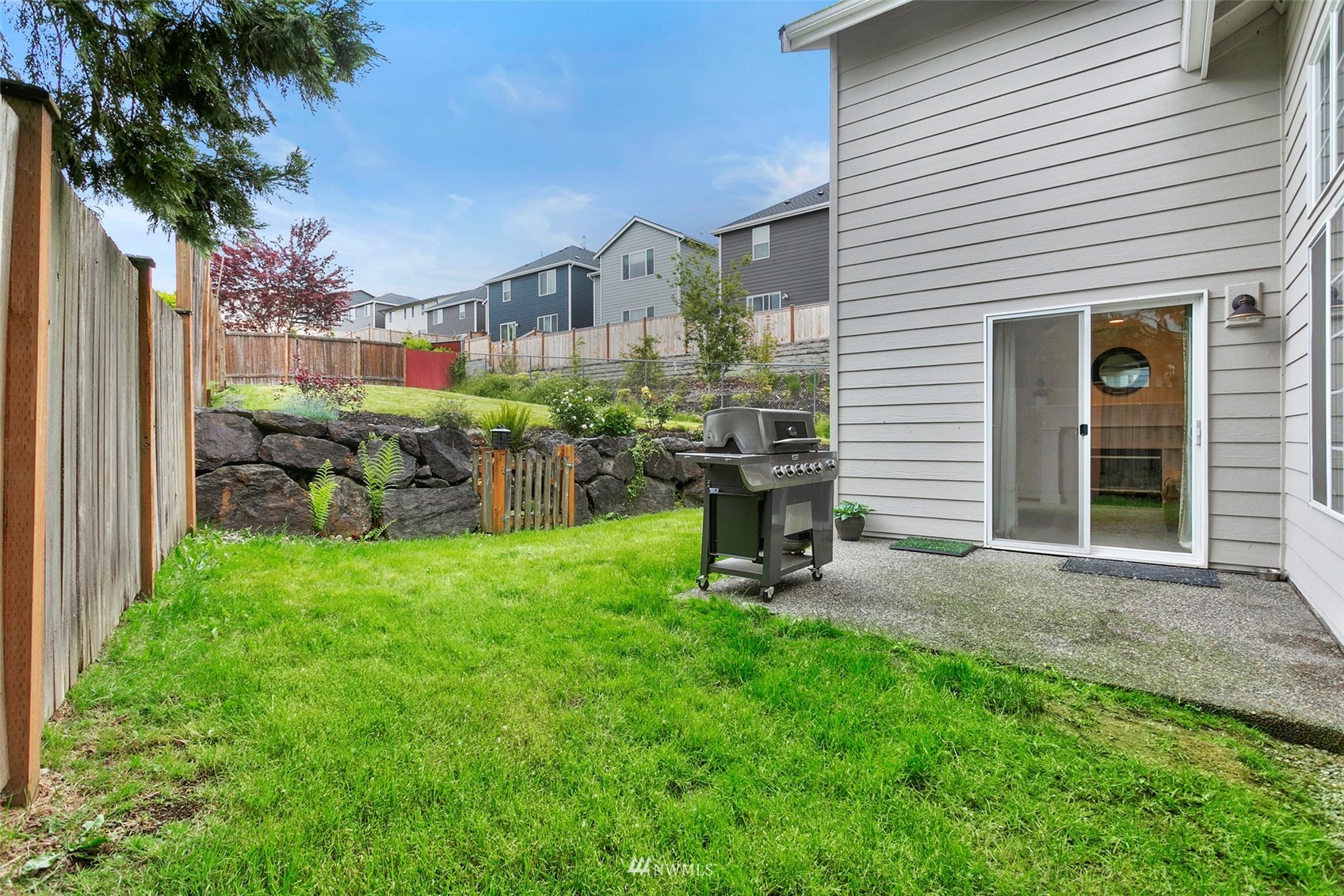 18487 Rainier View Road Southeast Monroe, WA 98272 - Photo 14 of 19 a view of a house with a backyard and porch
