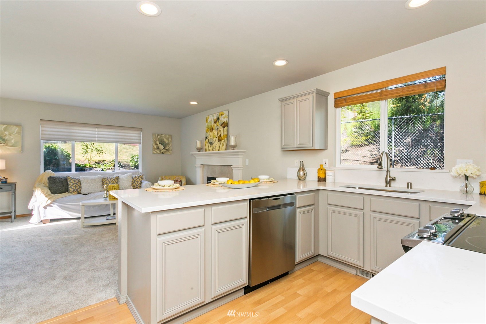 18487 Rainier View Road Southeast Monroe, WA 98272 - Photo 5 of 19 a kitchen with a sink cabinets and wooden floor
