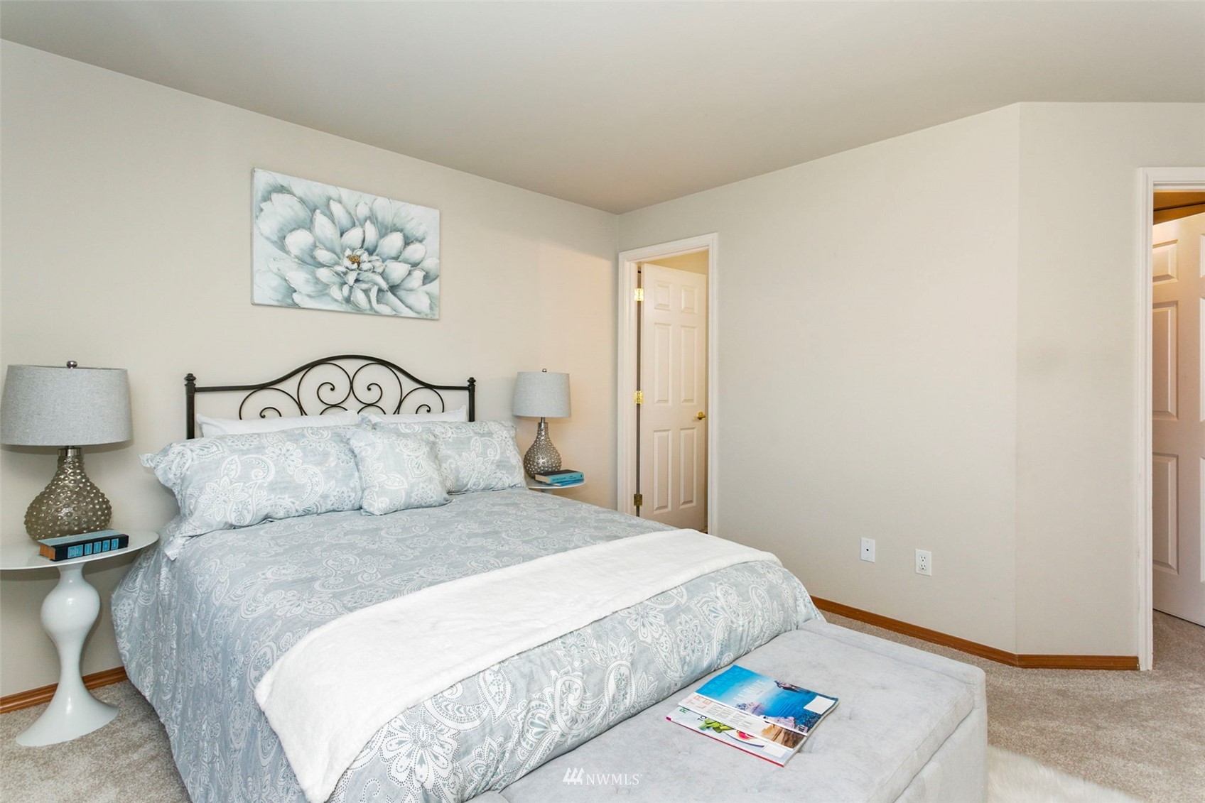 18487 Rainier View Road Southeast Monroe, WA 98272 - Photo 8 of 19 a bedroom with a bed and painting on the wall