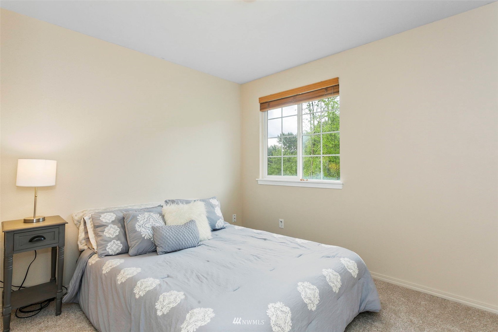 18487 Rainier View Road Southeast Monroe, WA 98272 - Photo 10 of 19 a bedroom with a bed and a lamp