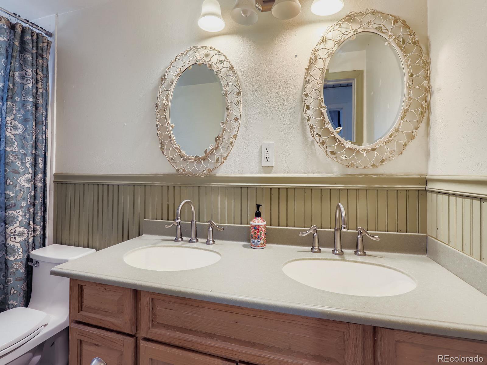 4292 North 119th Street Erie, CO 80516 - Photo 12 of 30 a bathroom with a granite countertop sink and a mirror