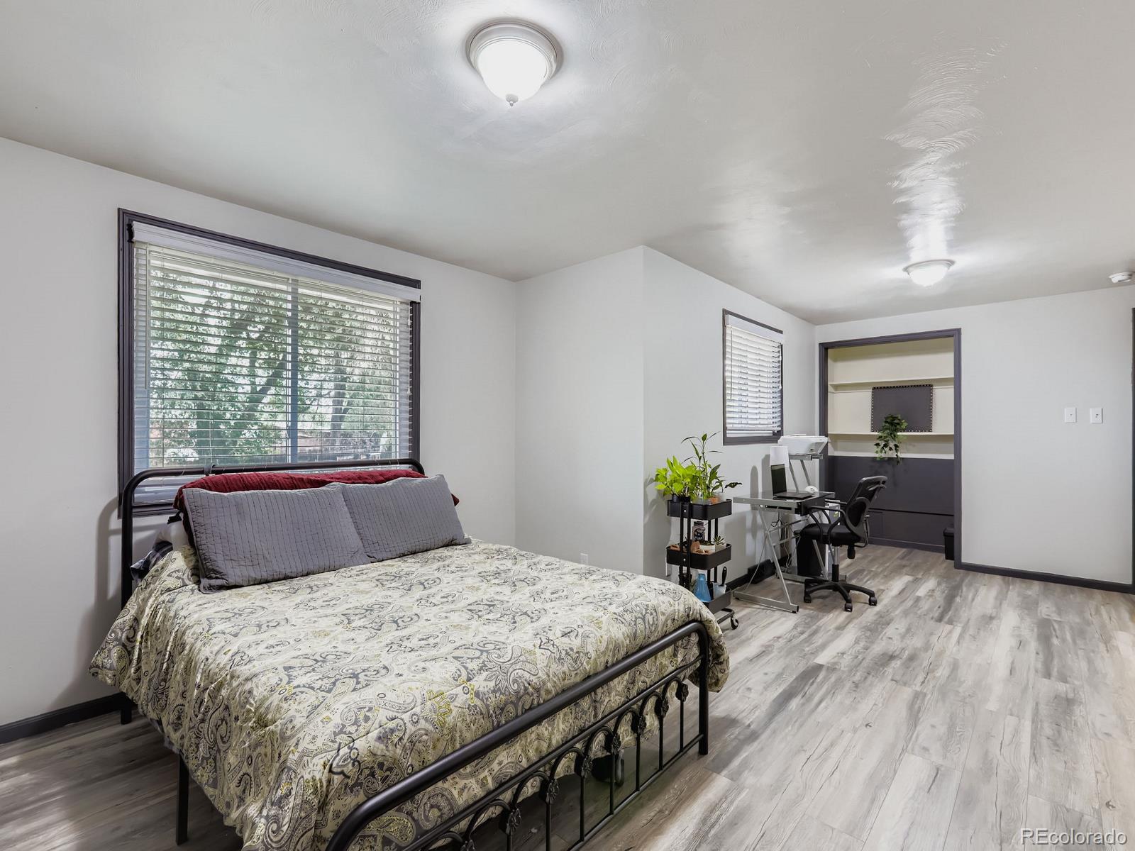 4292 North 119th Street Erie, CO 80516 - Photo 13 of 30 a bedroom with a bed a table and windows