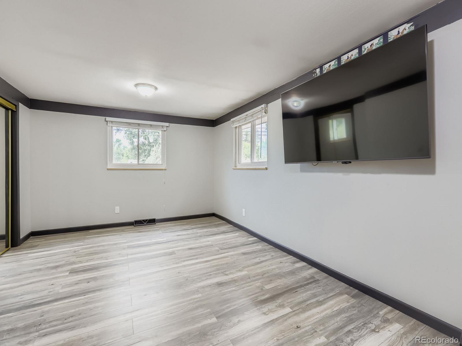 4292 North 119th Street Erie, CO 80516 - Photo 14 of 30 a view of an empty room with wooden floor and a window