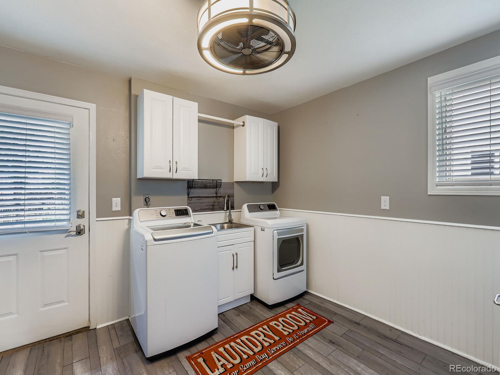 4292 North 119th Street Erie, CO 80516 - Photo 15 of 30 a kitchen with a stove and a white wooden cabinets
