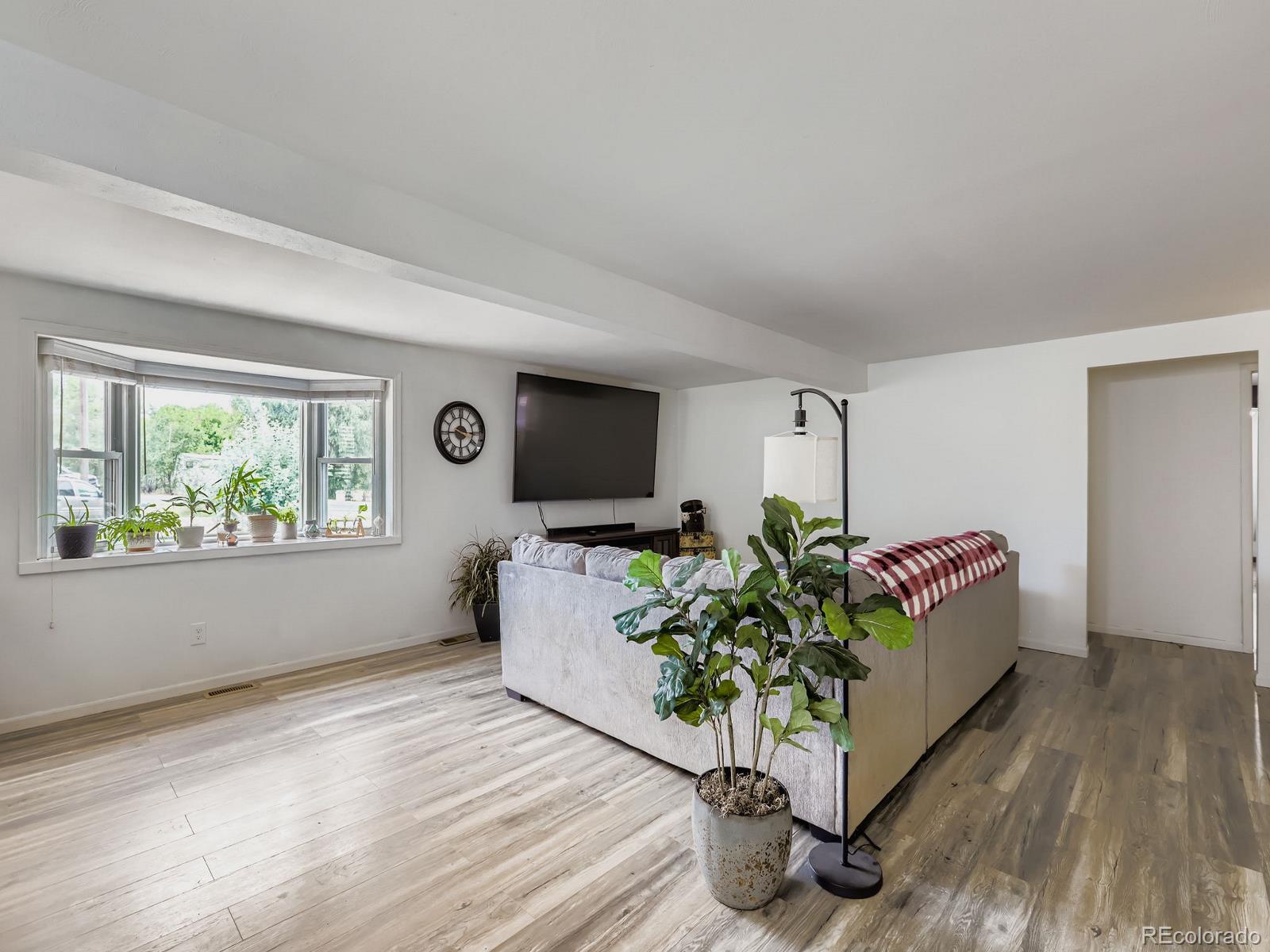 4292 North 119th Street Erie, CO 80516 - Photo 17 of 30 a living room with furniture and a flat screen tv