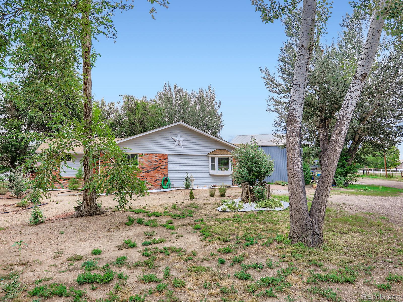 4292 North 119th Street Erie, CO 80516 - Photo 23 of 30 a view of a house with a tree in the background