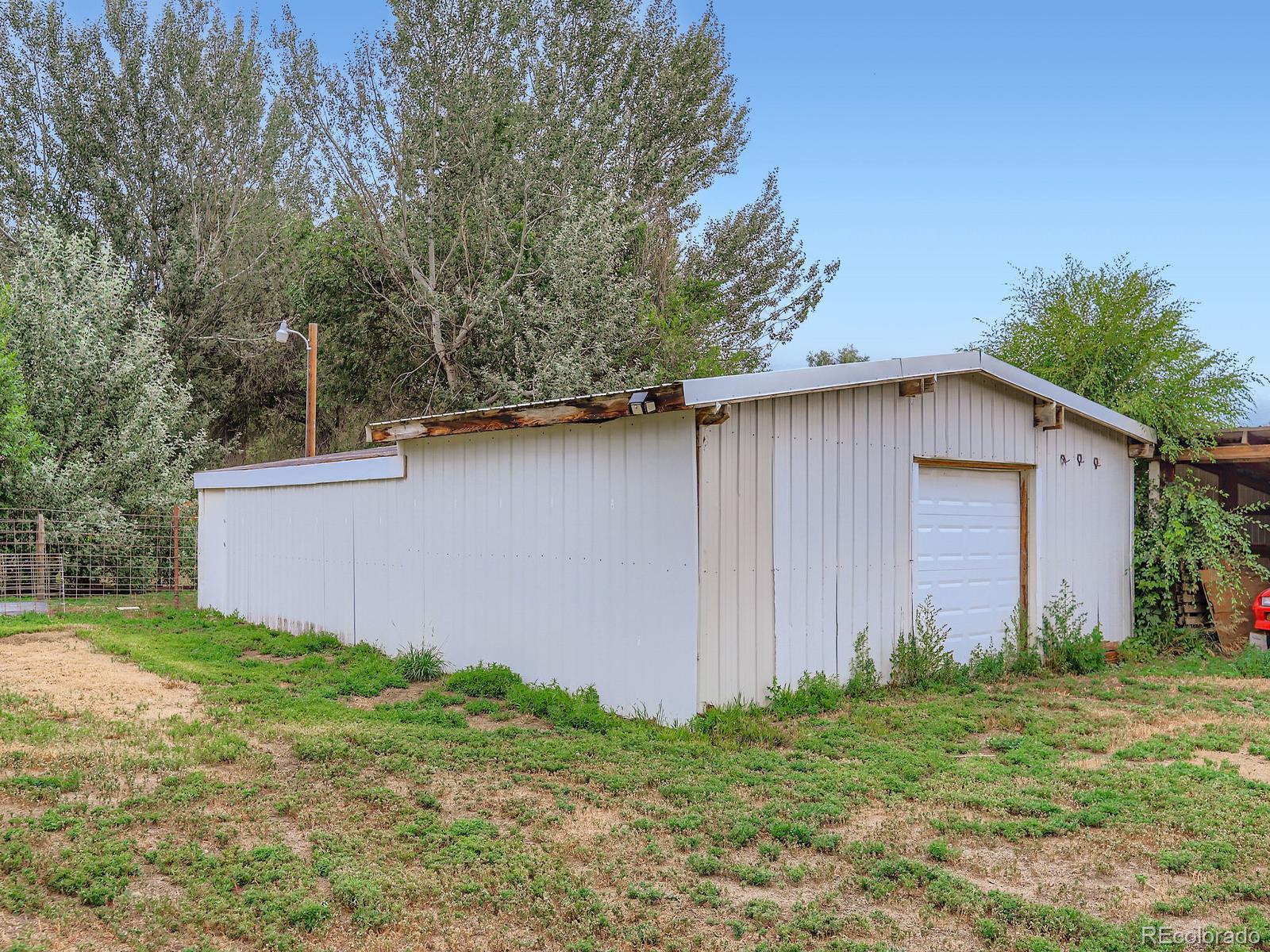 4292 North 119th Street Erie, CO 80516 - Photo 25 of 30 a backyard of a house with lots of green space