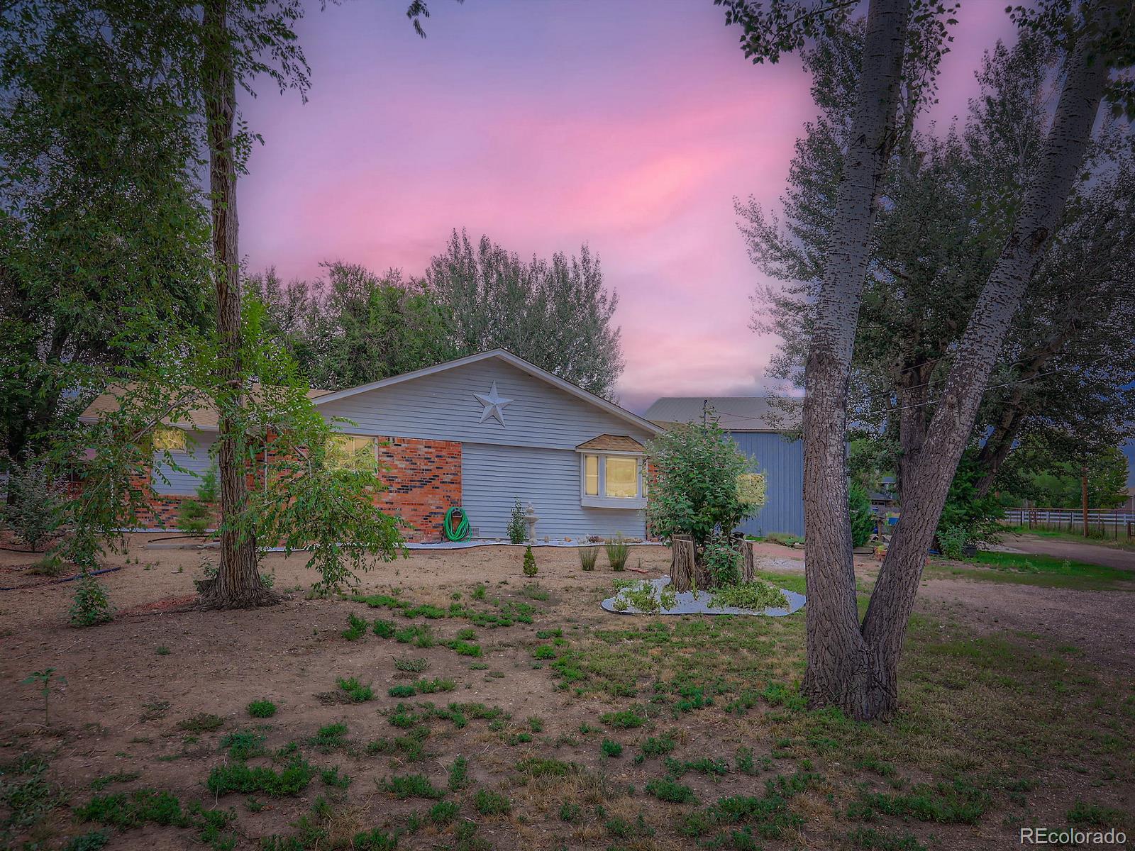 4292 North 119th Street Erie, CO 80516 - Photo 26 of 30 a front view of a house with a yard and large trees