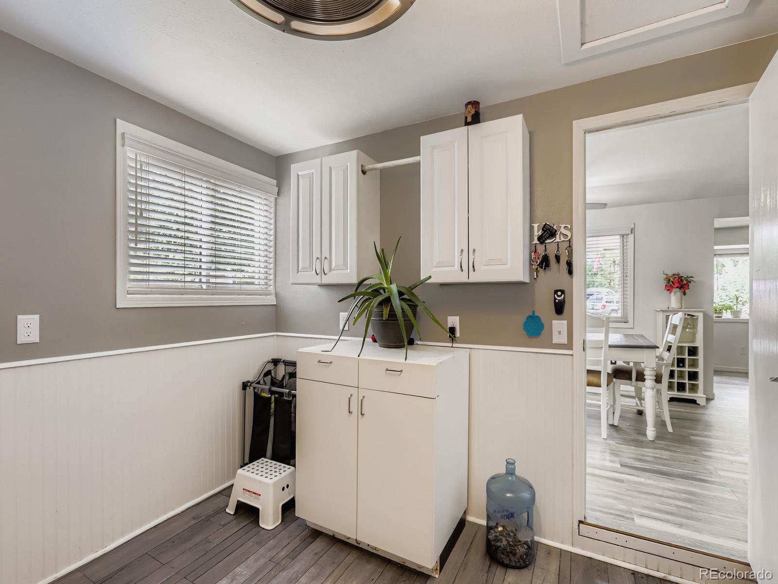 4292 North 119th Street Erie, CO 80516 - Photo 28 of 30 a room with kitchen island a white wooden cabinets a sink and a window
