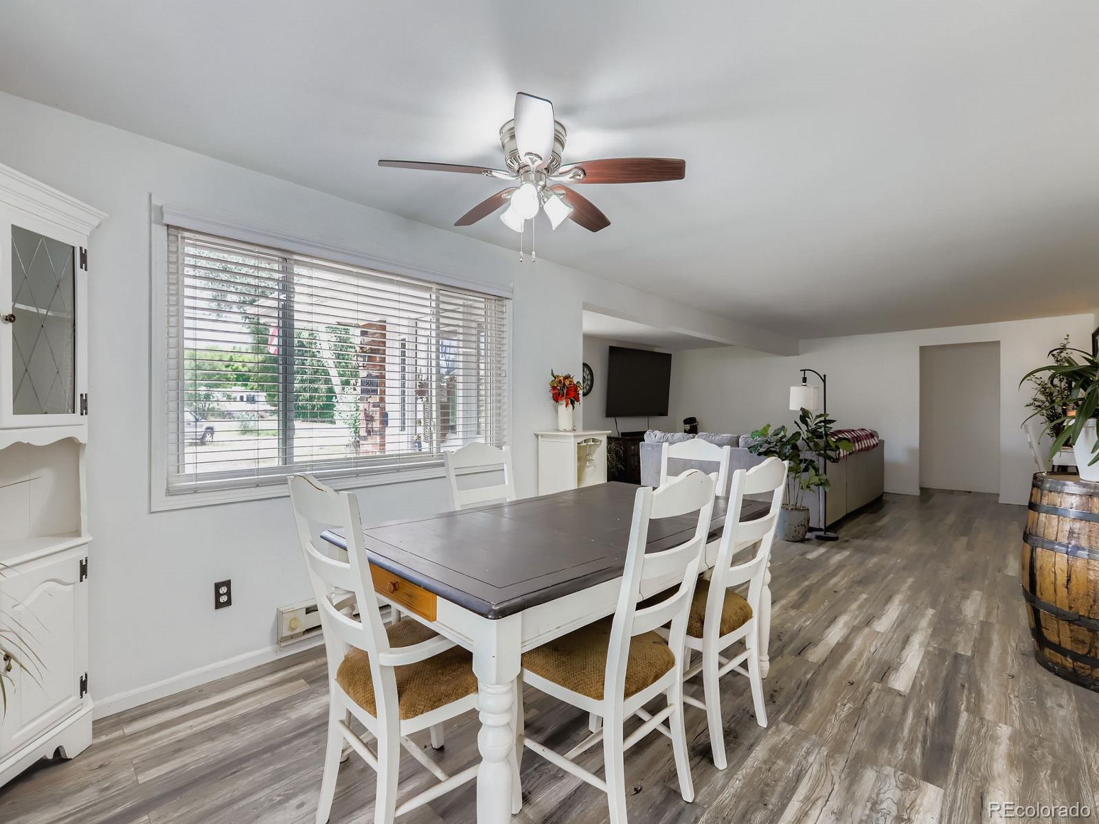 4292 North 119th Street Erie, CO 80516 - Photo 6 of 30 a view of a dining room with furniture window and wooden floor