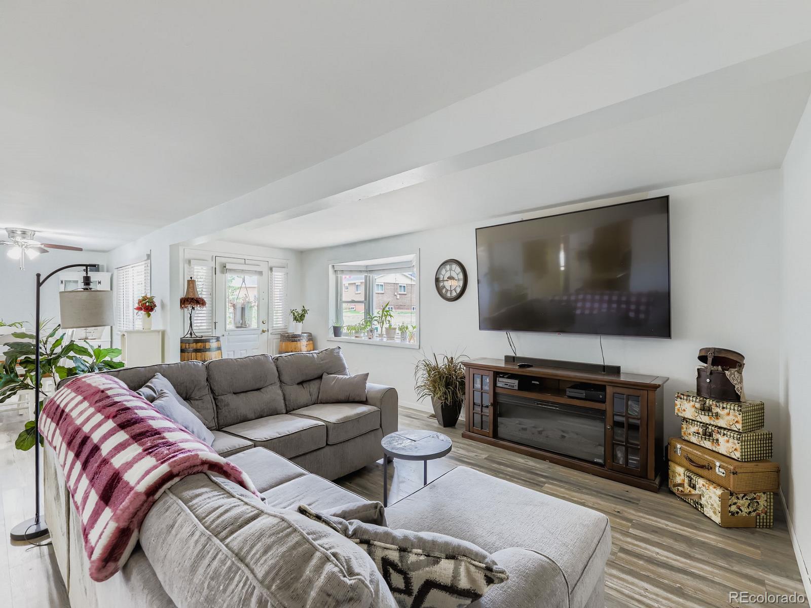 4292 North 119th Street Erie, CO 80516 - Photo 9 of 30 a living room with furniture and a flat screen tv