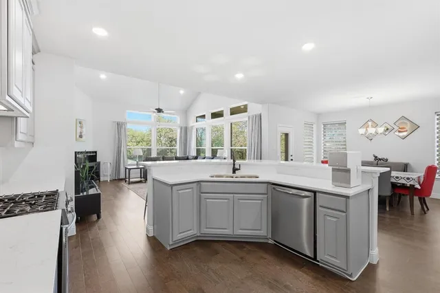 a large kitchen with a table and chairs in it