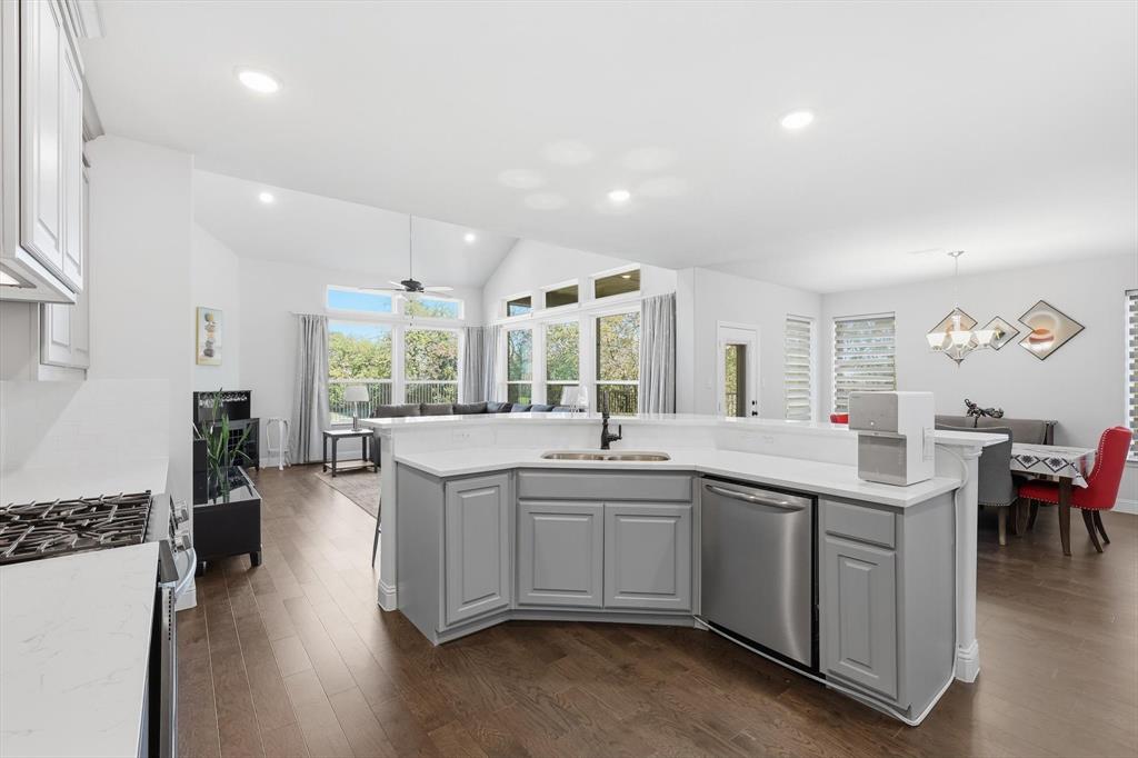 1988 Nottingham Place Allen, TX 75013 - Photo 12 of 40 Kitchen with gray cabinetry, dark wood-type flooring, recessed lighting, stainless steel appliances, and lofted ceiling