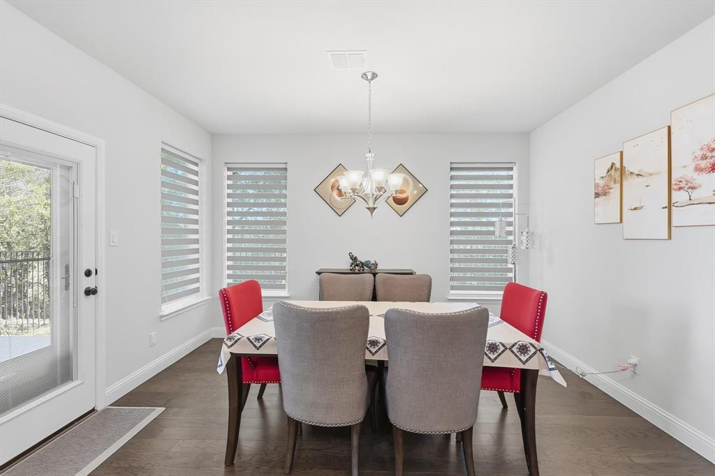 1988 Nottingham Place Allen, TX 75013 - Photo 14 of 40 Dining space with dark wood finished floors and a chandelier