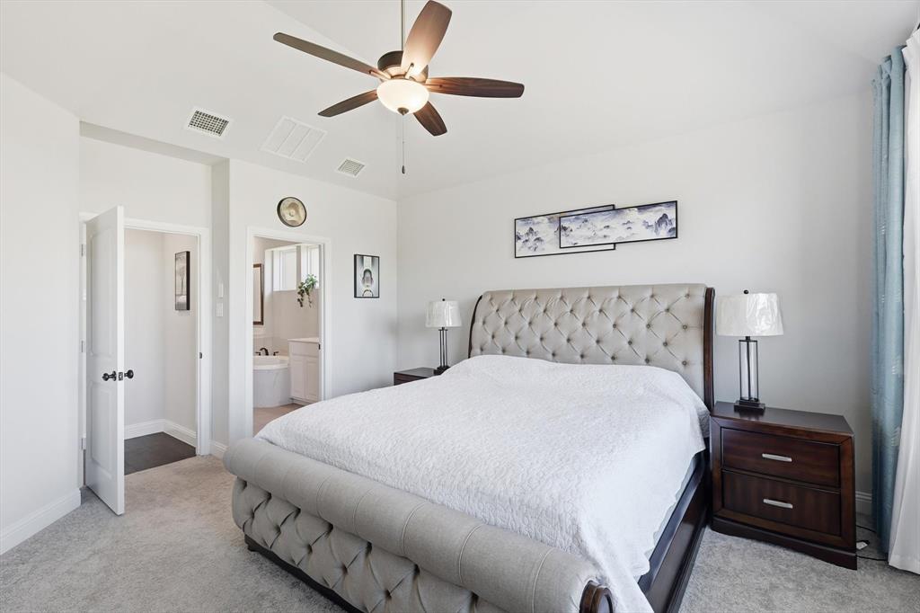 1988 Nottingham Place Allen, TX 75013 - Photo 21 of 40 Bedroom featuring light colored carpet, connected bathroom, and ceiling fan