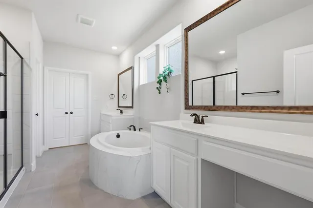 a bathroom with a double vanity sink and mirror