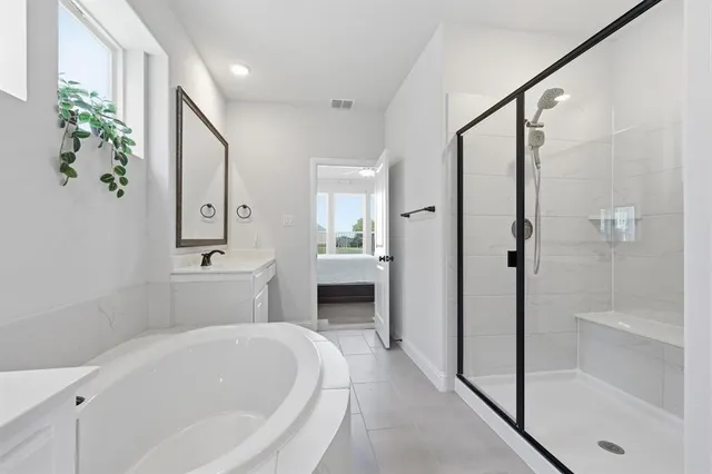 a spacious bathroom with a bathtub and a shower