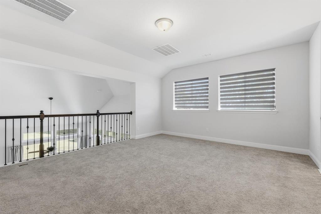 1988 Nottingham Place Allen, TX 75013 - Photo 25 of 40 Empty room with lofted ceiling and light carpet