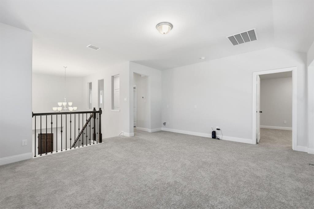 1988 Nottingham Place Allen, TX 75013 - Photo 26 of 40 Empty room featuring a chandelier and light colored carpet