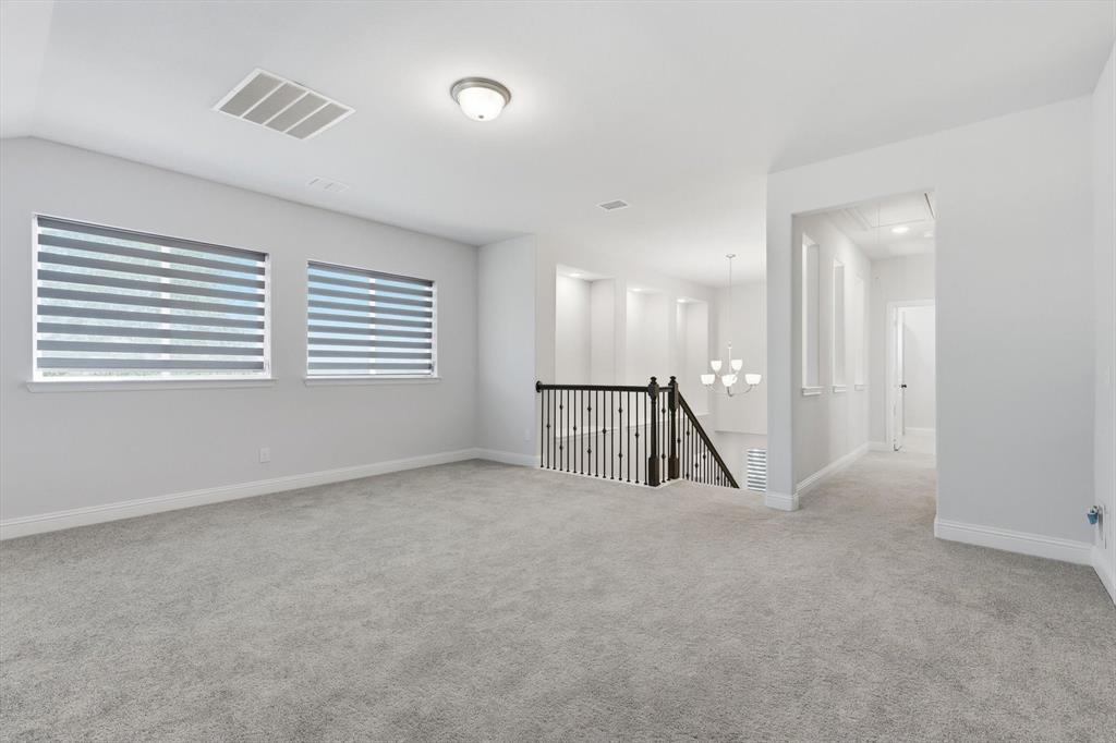 1988 Nottingham Place Allen, TX 75013 - Photo 27 of 40 Spare room featuring light carpet and a chandelier