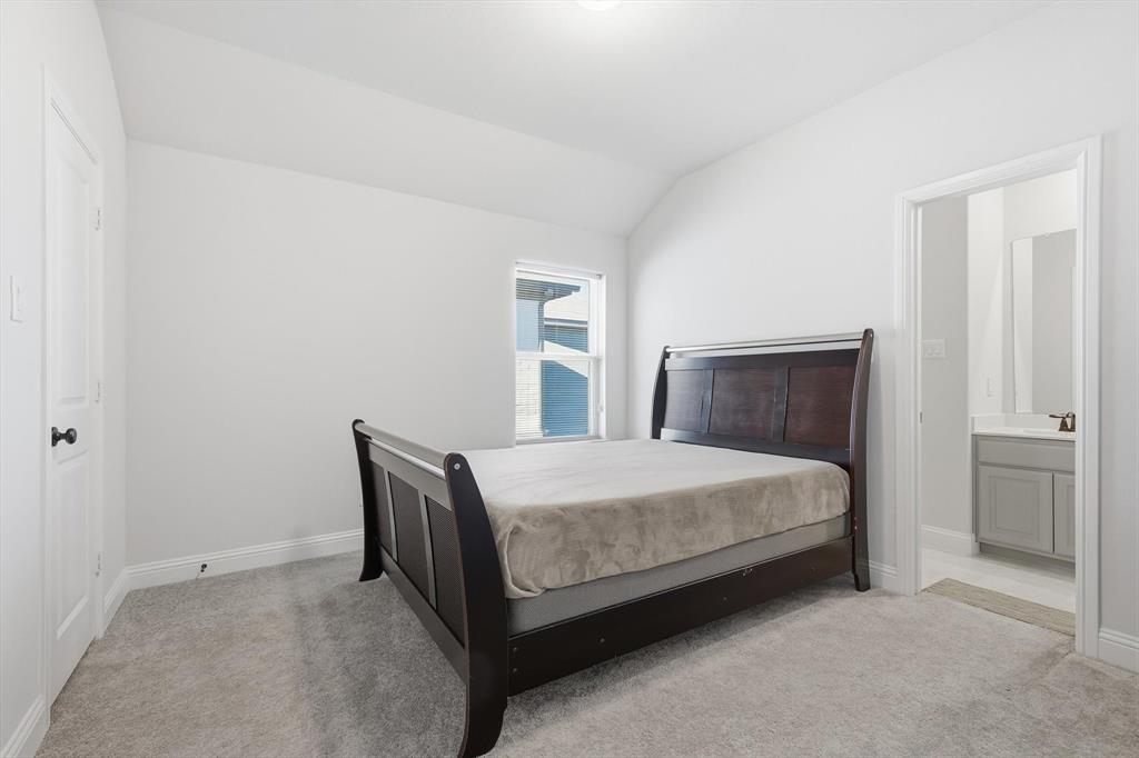 1988 Nottingham Place Allen, TX 75013 - Photo 31 of 40 Bedroom with lofted ceiling, light colored carpet, and ensuite bathroom