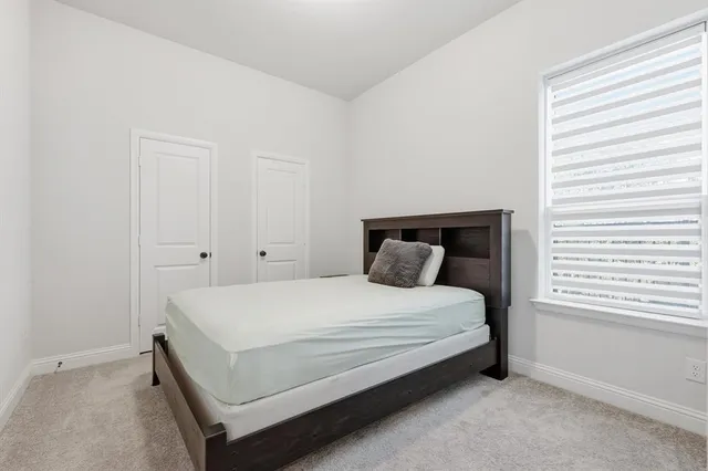 a bedroom with a bed and window