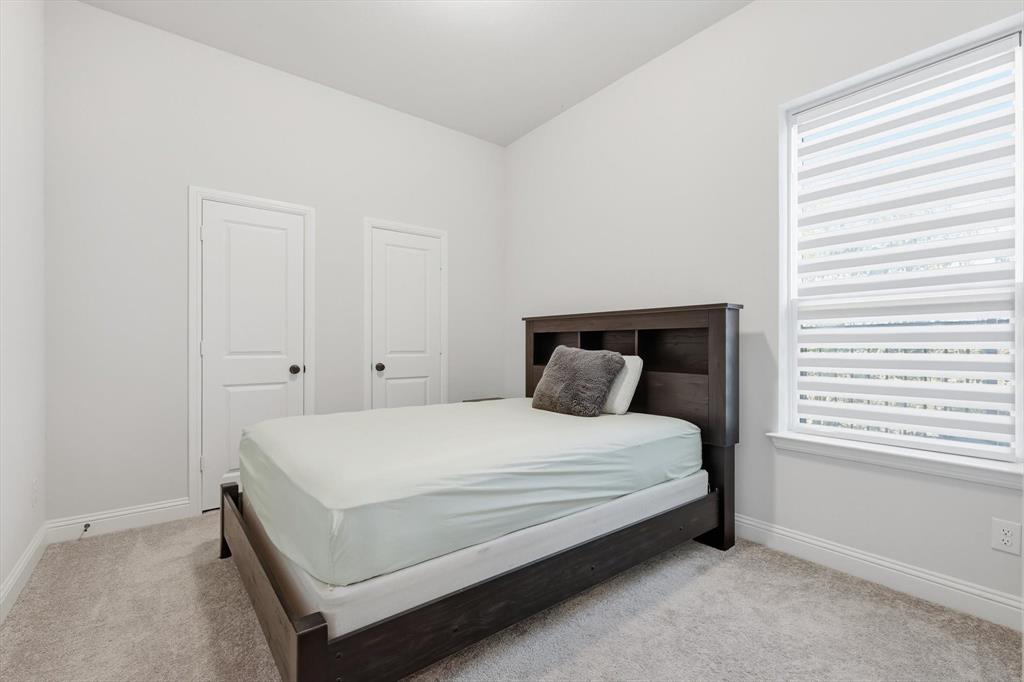 1988 Nottingham Place Allen, TX 75013 - Photo 8 of 40 Bedroom with light colored carpet and multiple windows