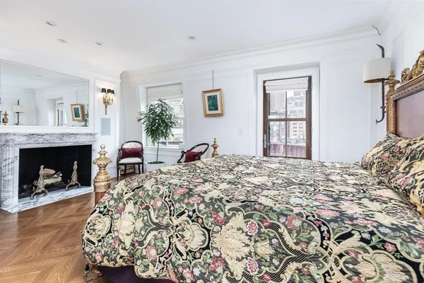 a bedroom with a bed and a fireplace