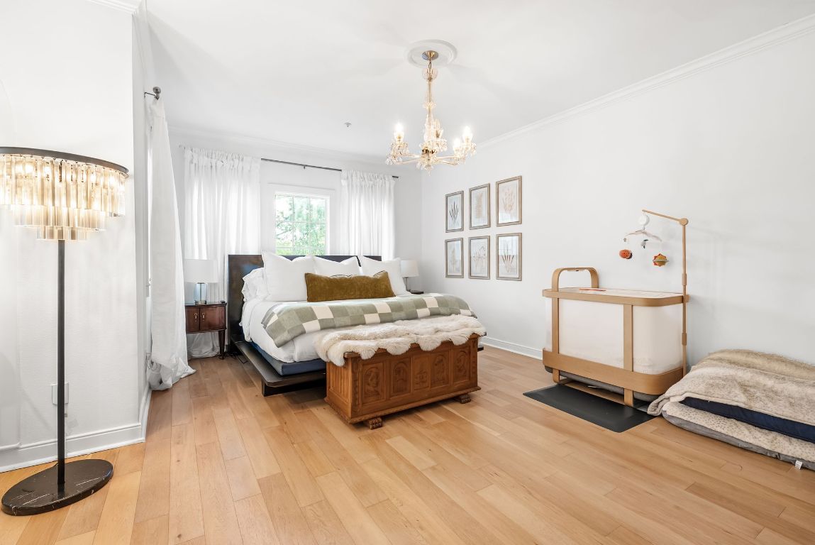 1937 Rue De St Tropez, Unit 10 Austin, TX 78746 - Photo 11 of 35 a bedroom with a bed and wooden floor