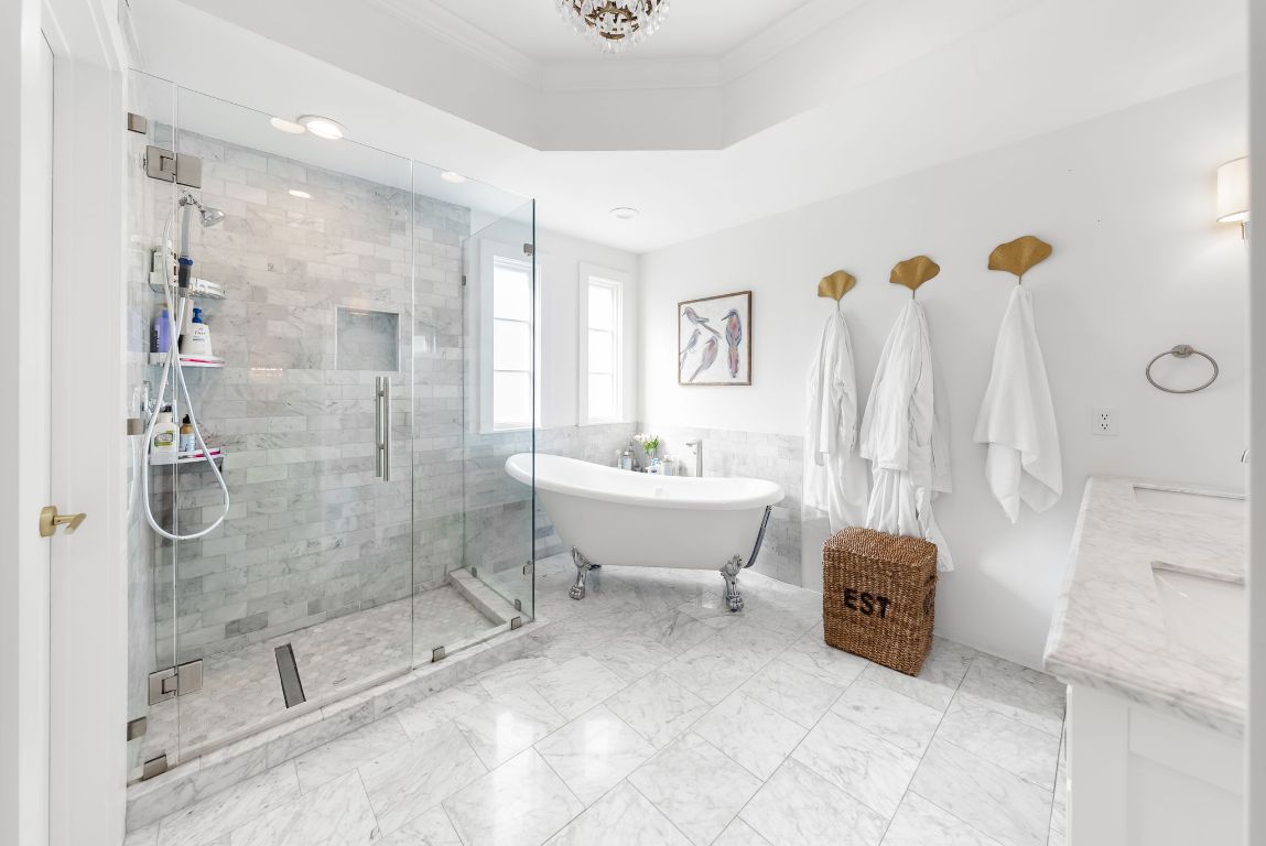 1937 Rue De St Tropez, Unit 10 Austin, TX 78746 - Photo 13 of 35 a bathroom with a tub sink and mirror