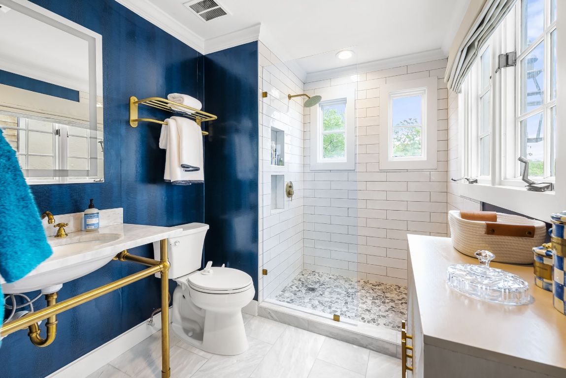 1937 Rue De St Tropez, Unit 10 Austin, TX 78746 - Photo 19 of 35 a bathroom with a sink a toilet and shower