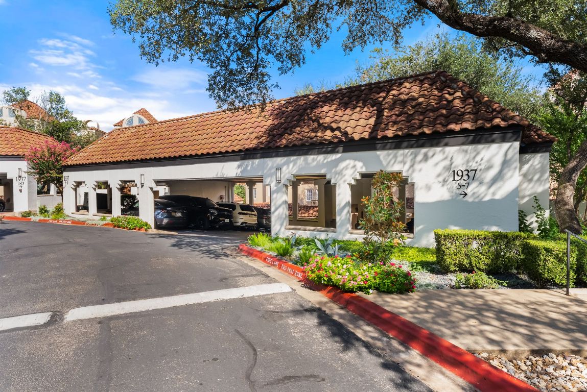 1937 Rue De St Tropez, Unit 10 Austin, TX 78746 - Photo 24 of 35 a front view of a house with a garden