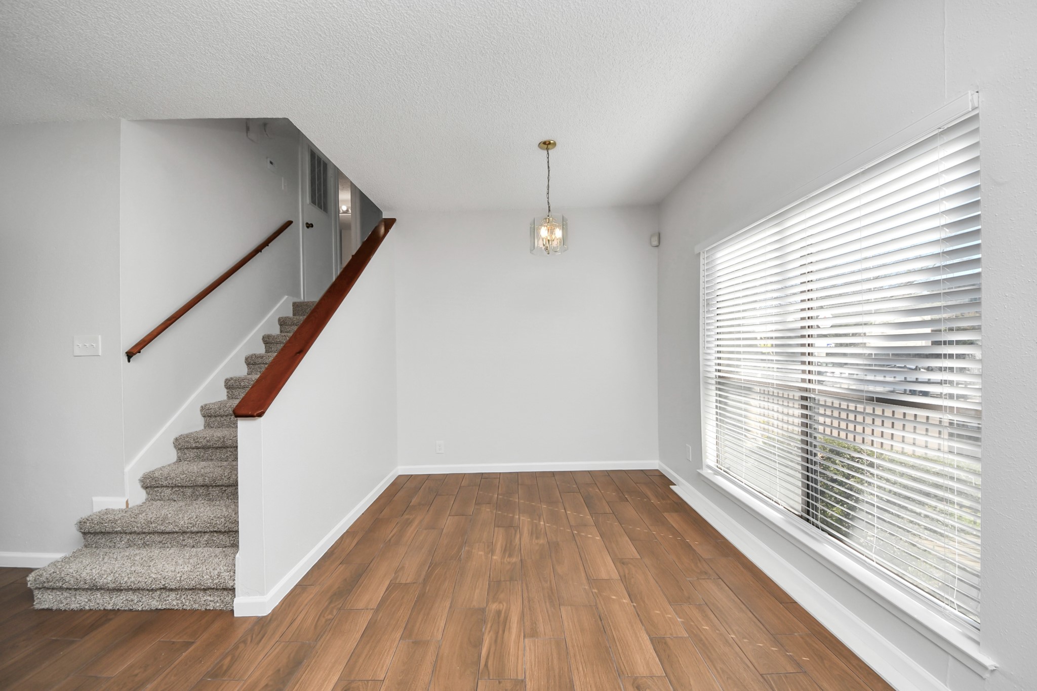 3750 Tanglewilde Street, Unit A7 Houston, TX 77063 - Photo 11 of 36 a view of a room with wooden floor and staircase