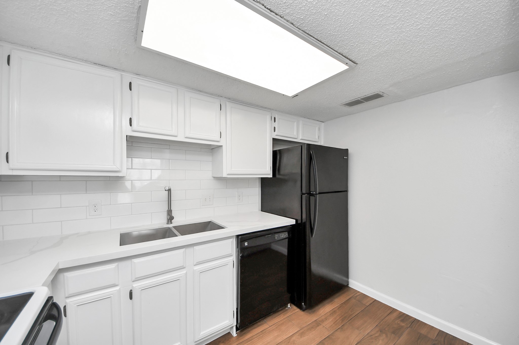 3750 Tanglewilde Street, Unit A7 Houston, TX 77063 - Photo 16 of 36 a kitchen with a sink appliances and cabinets