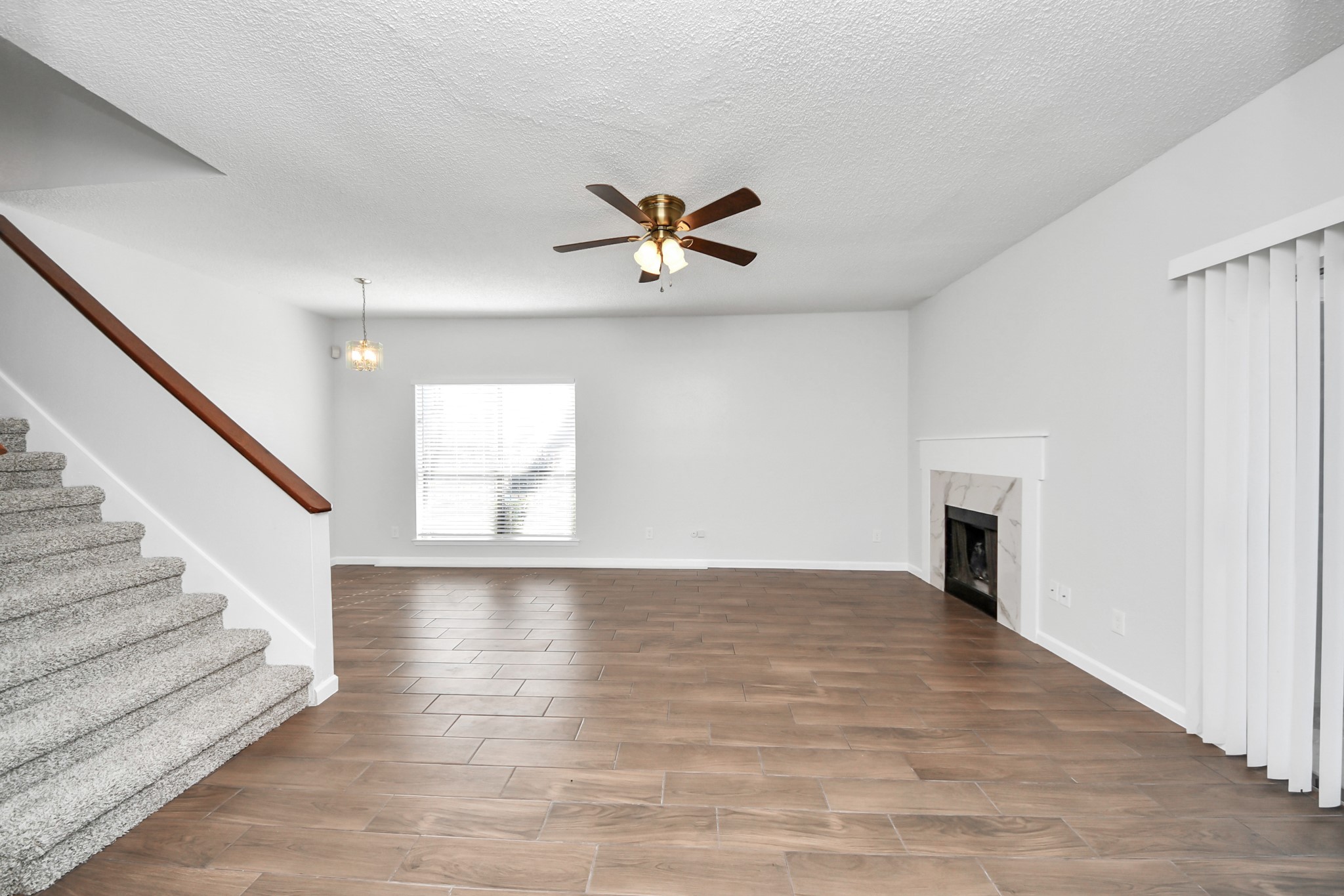 3750 Tanglewilde Street, Unit A7 Houston, TX 77063 - Photo 5 of 36 a view of empty room with wooden floor and fireplace