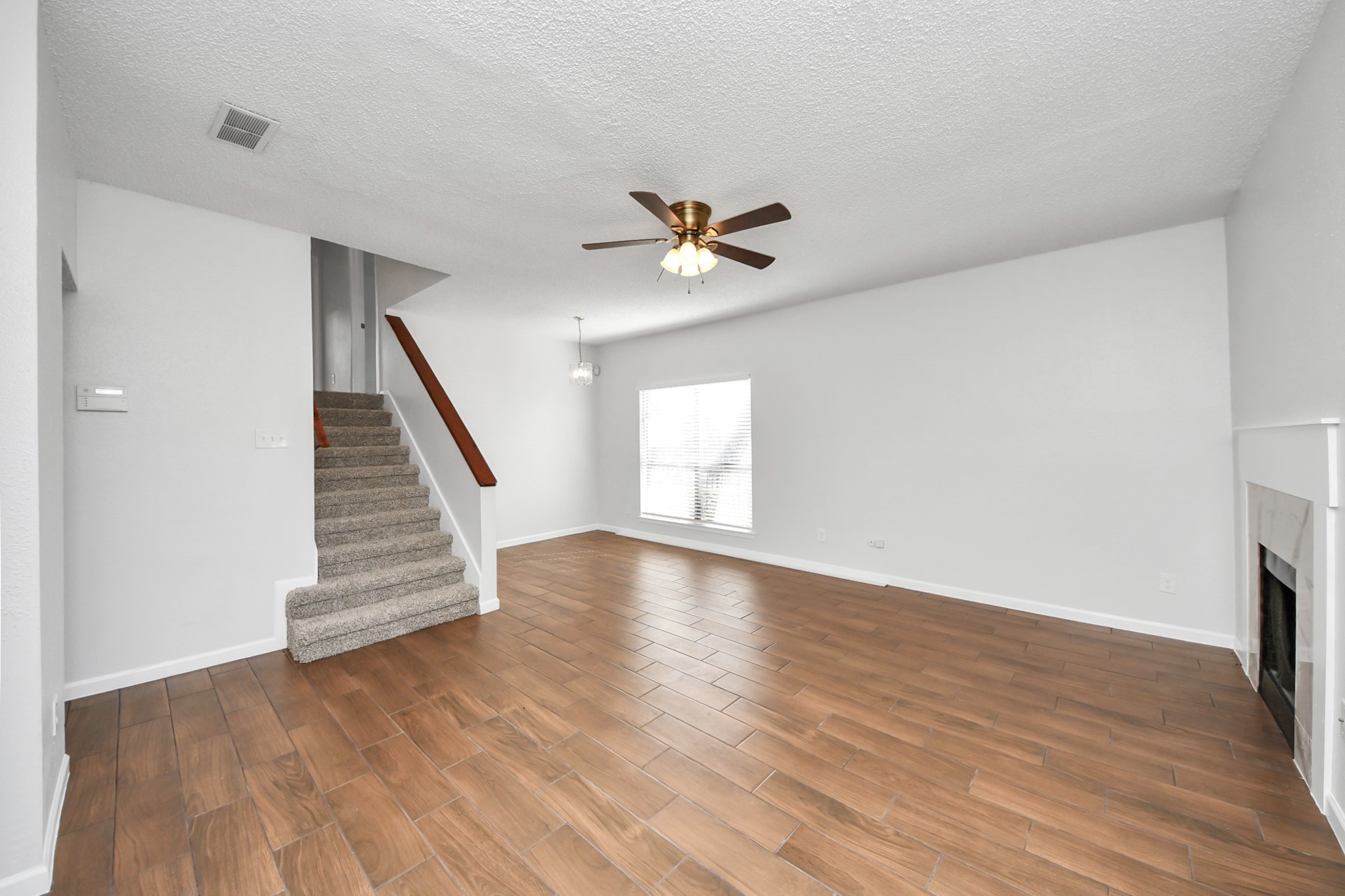 3750 Tanglewilde Street, Unit A7 Houston, TX 77063 - Photo 7 of 36 an empty room with wooden floor and ceiling fan