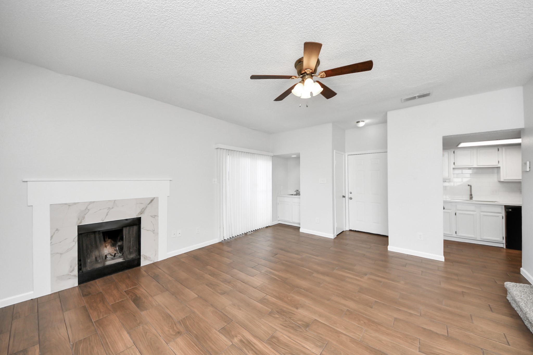 3750 Tanglewilde Street, Unit A7 Houston, TX 77063 - Photo 10 of 36 a view of empty room with wooden floor and fireplace