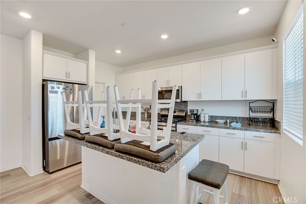2526 Gunner Ridge Way Rialto, CA 92377 - Photo 15 of 33 a kitchen with stainless steel appliances a sink stove and cabinets