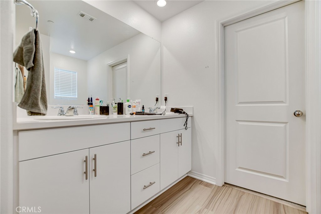 2526 Gunner Ridge Way Rialto, CA 92377 - Photo 22 of 33 a bathroom with a sink and a mirror